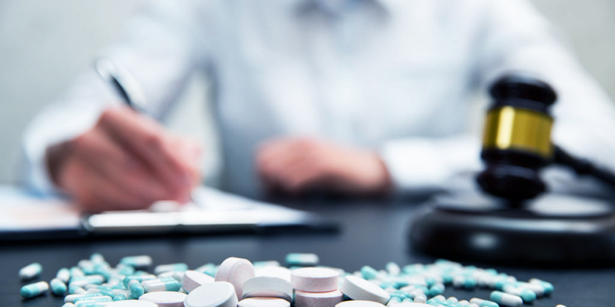 Medicine law concept. Judges gavel with pills